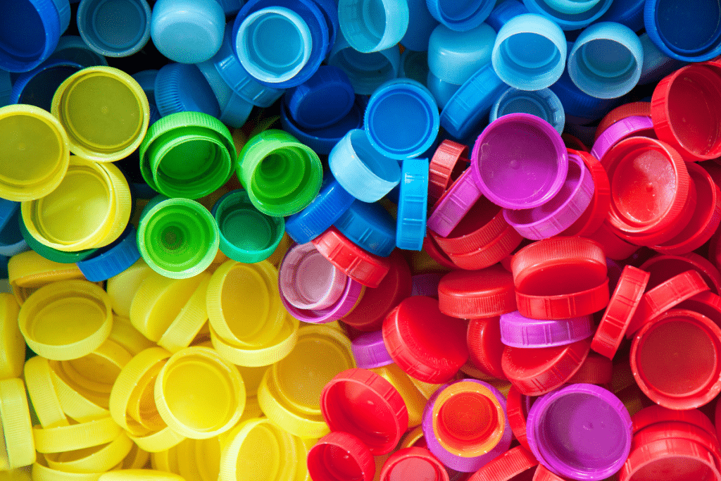 A pile of plastic bottle caps in assorted bright colors